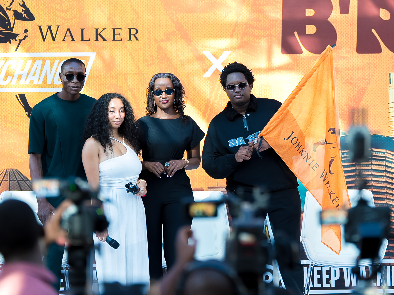 Musician Joshua Baraka being flagged off to his Ugandan tour by Christine Kyokunda, Brand Manager, Johnnie Walker Uganda